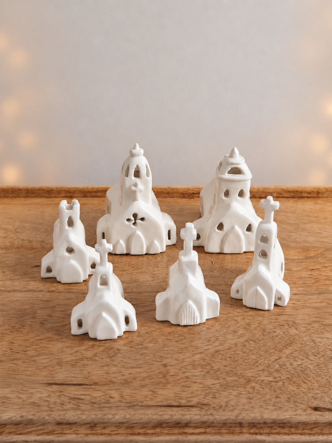 White ceramic church figurines with warm bokeh lights