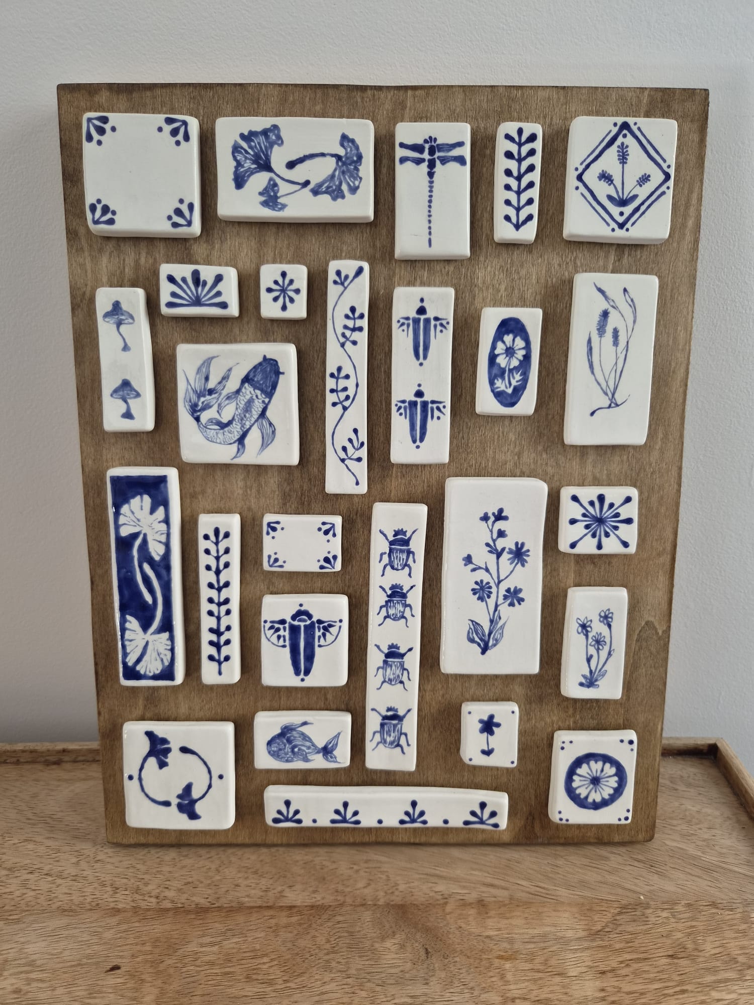 Blue and white ceramic tiles wooden board display